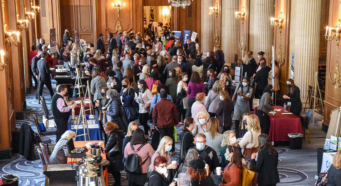 Overhead view of ornate hall filled with dozens of people