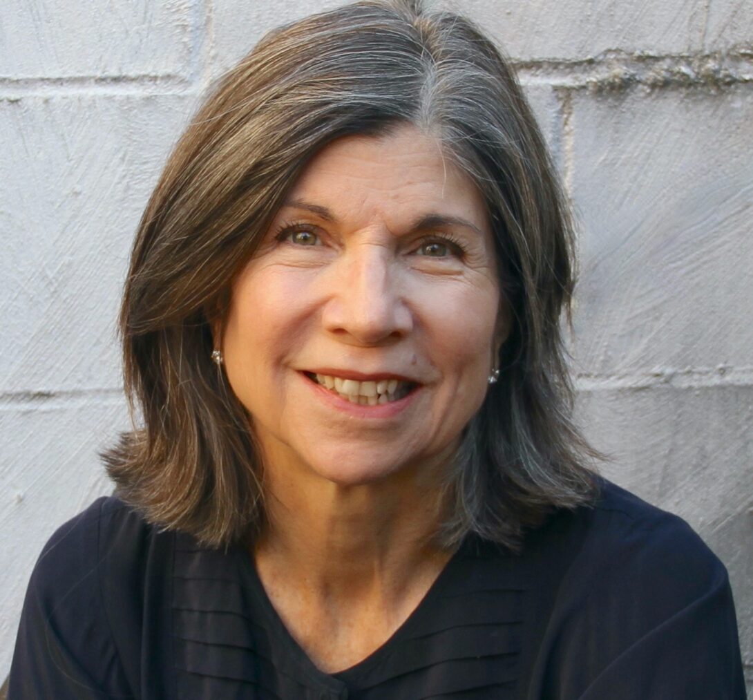 woman with medium length hair smiling.